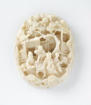  An intricately carved ivory-colored oval bas-relief depicting a scene with three humanoid figures surrounded by architectural elements, foliage, and potential animals on a neutral light background.