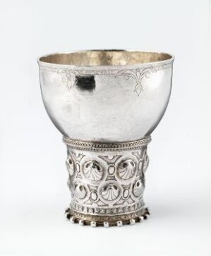  A meticulously crafted silver drinking cup known as "Drikkebeger" by an unidentified artist, featuring ornate decorations with symmetrical circular motifs and a structured base.