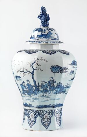  A traditional blue and white porcelain vase with a lid, displaying detailed pastoral scenes with figures and trees in shades of blue on a white background, and intricate geometric and floral patterns along its neck and base.