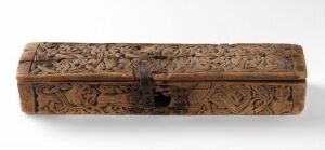  A wooden, carved, elongated rectangular box with intricate floral and geometric patterns, displayed against a white background. Artist name and title are unknown.