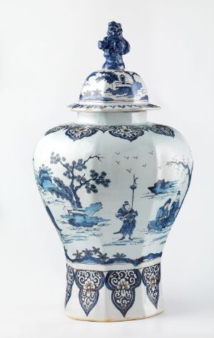  A traditional blue and white porcelain vase with a fitted lid, featuring intricate landscape and ornamental designs, on a white background.