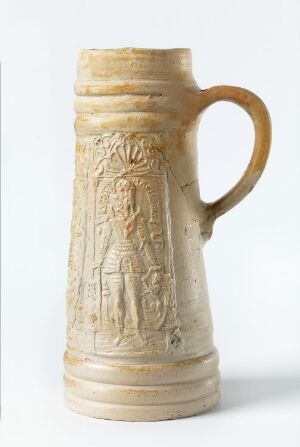  A stein made from creamy beige salt-glazed stoneware titled "Judas Maccabeus" by Virgilius Solis, featuring a bas-relief depiction of the historical figure Judas Maccabeus, surrounded by intricate relief patterns, with a sturdy handle on one side.