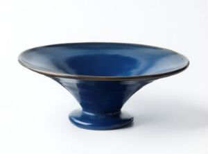  A glossy deep blue ceramic bowl with a fine rust-colored rim, presented against a plain white background.