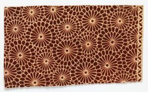  A patterned textile featuring a repetitive motif of stylized beige floral sunbursts on a dark brown background, displaying an intricate and traditional design.