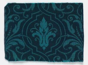  A swatch of fabric featuring an ornate pattern with various shades of teal, exhibiting a symmetrical design with swirls and a central plant-like motif.