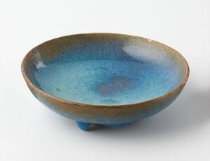  A ceramic bowl with a wide, open design featuring a blue gradient interior that transitions from sky blue to cobalt, and an earthy, unglazed brown exterior, displayed against a neutral gray background.