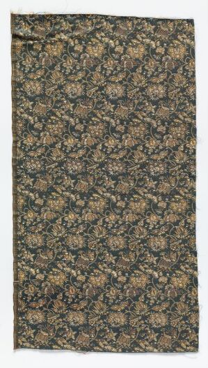  A vertical textile with a dense, intricate floral and foliage pattern in shades of green, orange, gold, and hints of blue, bordered with a neat edge at the top and bottom.