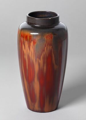  A glossy vase with a narrow neck and broad body, featuring streaks of fiery orange and deep brown colors, on a neutral grey background.