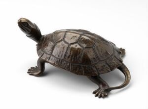  A metal sculpture of a turtle with a detailed dark brown shell on a plain white background, suggesting an object of art or functionality.