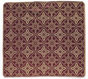  A richly patterned square textile with a deep burgundy background and a repetitive diamond grid pattern in white and gold, featuring intricate symmetrical designs and framed by a thin gold border.