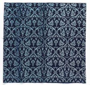  A square piece of artwork with a dark navy blue background and an intricate, symmetrical pattern in lighter blues and white, featuring floral motifs and curling vines, which resemble a traditional textile or wallpaper design.