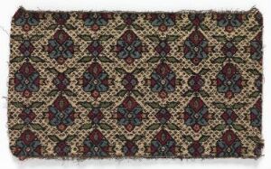  An antique textile with a dense, repetitive, diamond-shaped pattern in maroon, dark green, and beige over a dark background, showing signs of wear and frayed edges. Artist name and title unknown.