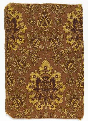  An intricate pattern with brown and golden-yellow hues featuring symmetrical floral and emblem-like motifs, suggesting a traditional decorative design, possibly of historical Middle Eastern or South Asian influence.