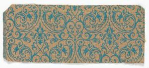  Horizontal rectangular textile or paper with an aged beige background showcasing a symmetrical pattern with teal and rusty orange arabesque motifs.