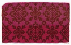  A rectangular piece of textile with an elegant floral pattern in shades of deep magenta and darker burgundy, providing a sense of traditional ornamental design.