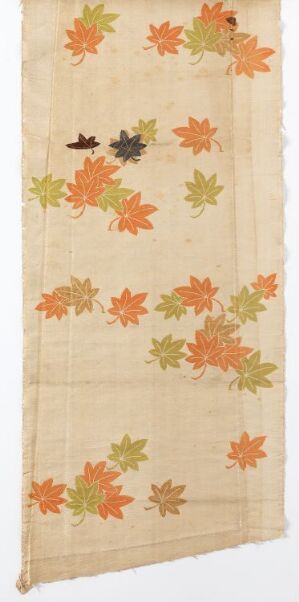  A long, vertical textile panel with a cream-beige background and scattered maple leaves in shades of orange, yellow, green, and brown, suggesting an autumnal theme with a delicate transparent texture.