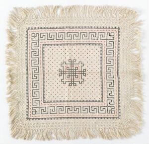  Square textile artwork with fringe edges and a central symmetrical pattern in shades of beige, featuring a Greek key border and intricate geometric shapes.