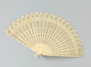  An elegant, semi-circular, cream-colored hand fan with delicate lace-like cutout patterns on its ribs, displayed against a plain grey background. Artist name and title are unknown.