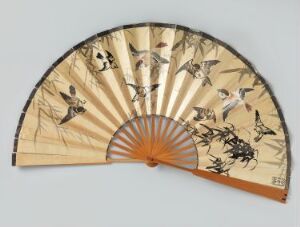  An open traditional East Asian folding fan with a tan paper surface and hand-painted sparrows in various poses over the wooden ribs. The fan combines natural beige, gray, black, and white tones with orange-brown wooden elements.