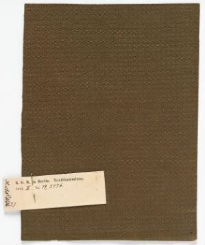  A textured brown fabric swatch mounted on a lighter brown backing with a white label in the lower left corner, details of which are indistinct.