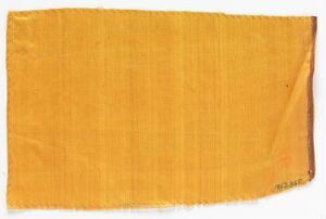  A rectangular, deep yellow textile with a coarse texture and a hemmed edge, displayed against a neutral background. The top right corner shows some fraying, while the rest of the fabric is uniformly colored.