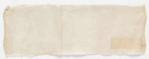  A long, horizontal strip of aged, creamy beige fabric or paper on a white background, with a slightly darker beige patch on the right side. No artist name or title provided.