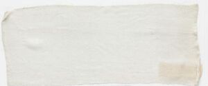  An image of a simple, rectangular off-white piece of fabric with a slight wrinkle and a faint yellowish-brown stain on one edge, artist and title unknown.