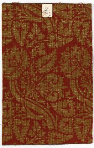  A patterned fabric swatch with an intricate, intertwining botanical design, rendered in contrasting shades of deep maroon and lighter golden tones, suggesting a vintage or classic style.