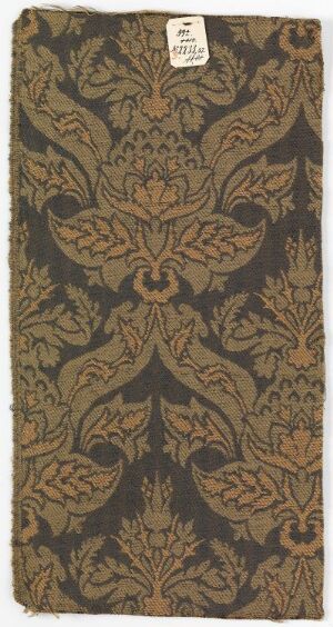  A rectangular piece of fabric or wallpaper featuring a symmetrical and intricate pattern of floral designs and scrollwork in muted olive green, tan, and soft bronze hues.