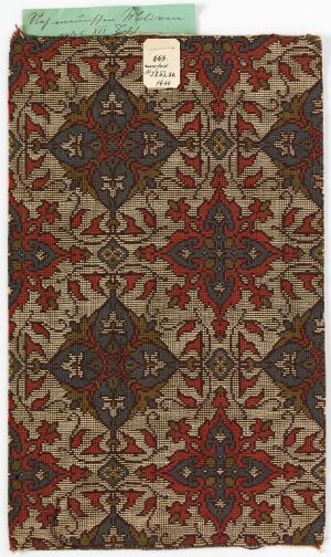  An antique fabric with a symmetrical pattern featuring a predominant rich crimson red background with dark brown accents and beige highlights, depicting traditional geometric and floral designs.