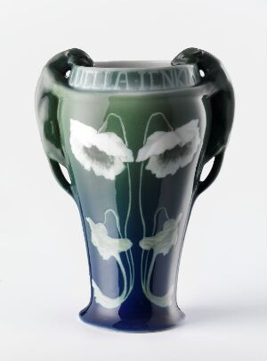  A Georg Andreas Heggelund feldspar porcelain vase with dark green to navy blue gradient and white underglaze floral design, featuring curvaceous handles.