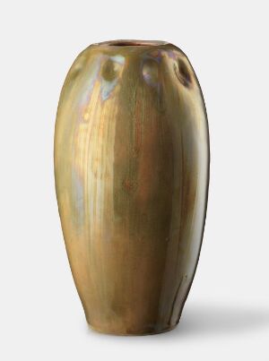  A glazed ceramic vase with a tapered shape displaying a gradient of colors from iridescent pale gold and blue at the top to honey gold in the middle and olive green with brown striations towards the base, all set against a light gray background. Artist name and title are unknown.