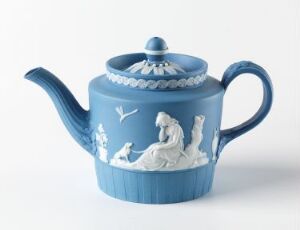  A pastel blue teapot with white bas-relief decoration depicting a classical scene with human figures, an animal, and nature elements, set against a plain white background. The teapot features a rounded body, curved spout, and a C-shaped handle. Artist name and title are unknown.