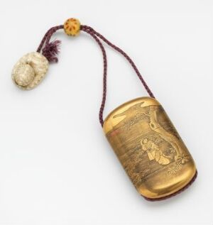  A golden-colored, oval-shaped ornamental amulet with engraved art on its surface, attached to a maroon cord with an amber bead and an off-white tassel, against a white background.