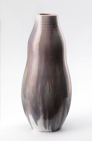  Tall, slender vase with a shimmery surface fading from silvery gray at the top to dark charcoal at the bottom, adorned with vertical black streaks reminiscent of wood grain or ink against a plain white background.