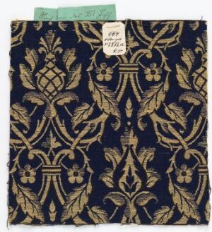  A piece of navy blue fabric with a symmetrical metallic gold and olive green ornate pattern, featuring fleur-de-lis and stylized plant motifs, with a white price tag in the upper left corner.