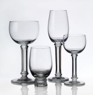  A set of four elegantly designed clear glass tableware pieces by Kari Ulleberg, with varying heights and bowl shapes, arranged against a clean white background.