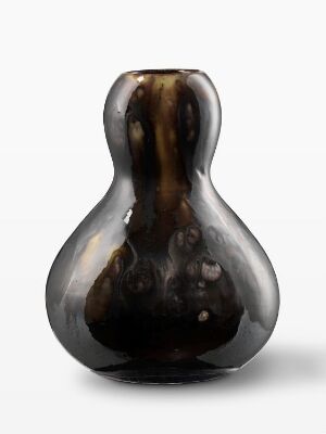  A gourd-shaped, highly polished object with a dark brown to almost black color palette and subtle bronze highlights, set against a simple light grey background, conveying a sense of contemporary art or sophistication.