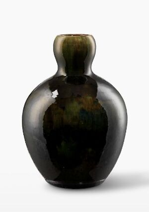  A dark, almost black vase with a bulbous body and narrow neck, displaying subtle transitions of dark bronze to green and hints of brown across its glazed surface, set against a light grey background. Artist name and title are unknown.