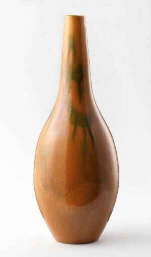  An elongated, tan-colored vase with a shiny finish and a green streak running down from the top, set against a white background.