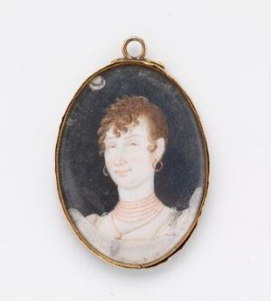  An oval-shaped miniature portrait in a gold-toned frame featuring a fair-skinned woman with curly red hair, a white collar, and a coral necklace against a dark background.