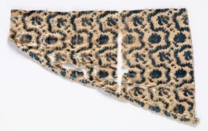  A piece of fabric with a leopard print pattern featuring dark brown and black rosettes on a beige background, spread out to display the design. Artist name and title are unknown.