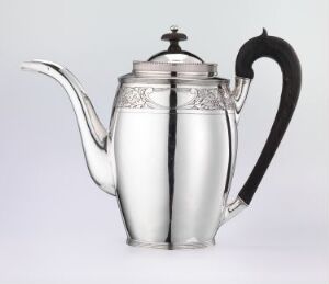  A polished silver teapot with decorative bands and a black handle, set against a light grey background.