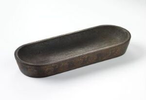  A dark grey, elongated oval-shaped shallow metal dish with a textured surface, resting on a light grey background.