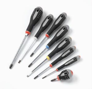  A set of nine ergonomic black and gray screwdrivers with color accents designed by Ergonomi Design Gruppen (M. Benktzon S-E. Juhlin), featuring comfortable grips and various head types, displayed against a white background.