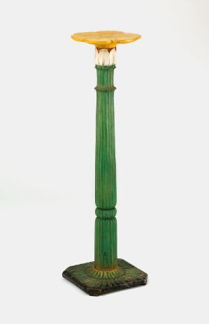  A tall, stylized decorative column on a square base, with a vibrant emerald green segmented shaft and a contrasting glowing orange top, set against a plain background.Artist name and title unknown.