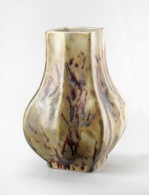  A glossy ceramic vase with an organic shape and a mottled pattern of creamy off-white, tans, browns, greys, and hints of mauve creating a marbled appearance.