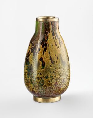  A tapering vase with a golden amber color and a pattern of dark brown and moss green spots, giving it an antiqued metallic appearance, finished with a polished golden band at the base.