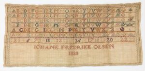  An antique embroidered sampler on light beige fabric showing multiple rows of the alphabet and numbers in varying stitches and colors, with the name "Johane Fredrike Olsen" and the year "1830" stitched at the bottom.