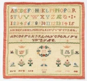  An antique needlework sampler featuring a natural beige background and a red stitched border, displaying rows of multi-colored alphabets and numbers at the top, intricate floral and geometric borders in the middle, and symmetrical floral and bird designs at the bottom.